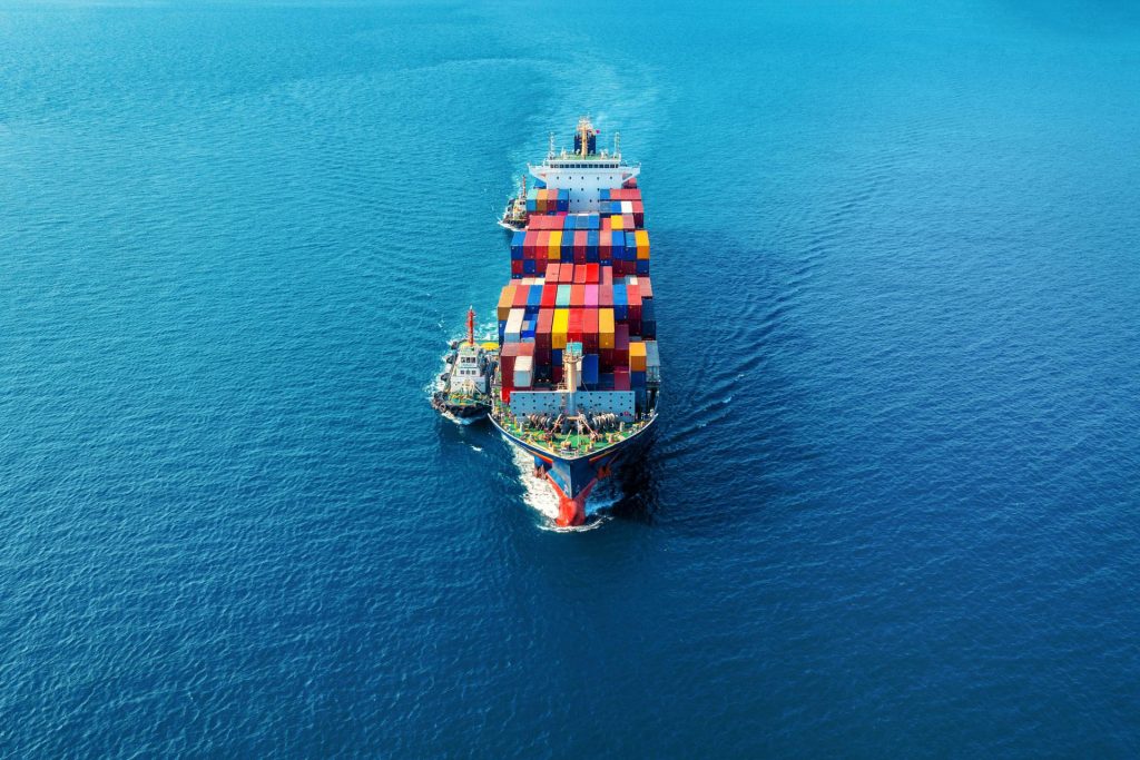 Aerial view of a cargo ship carrying containers at sea